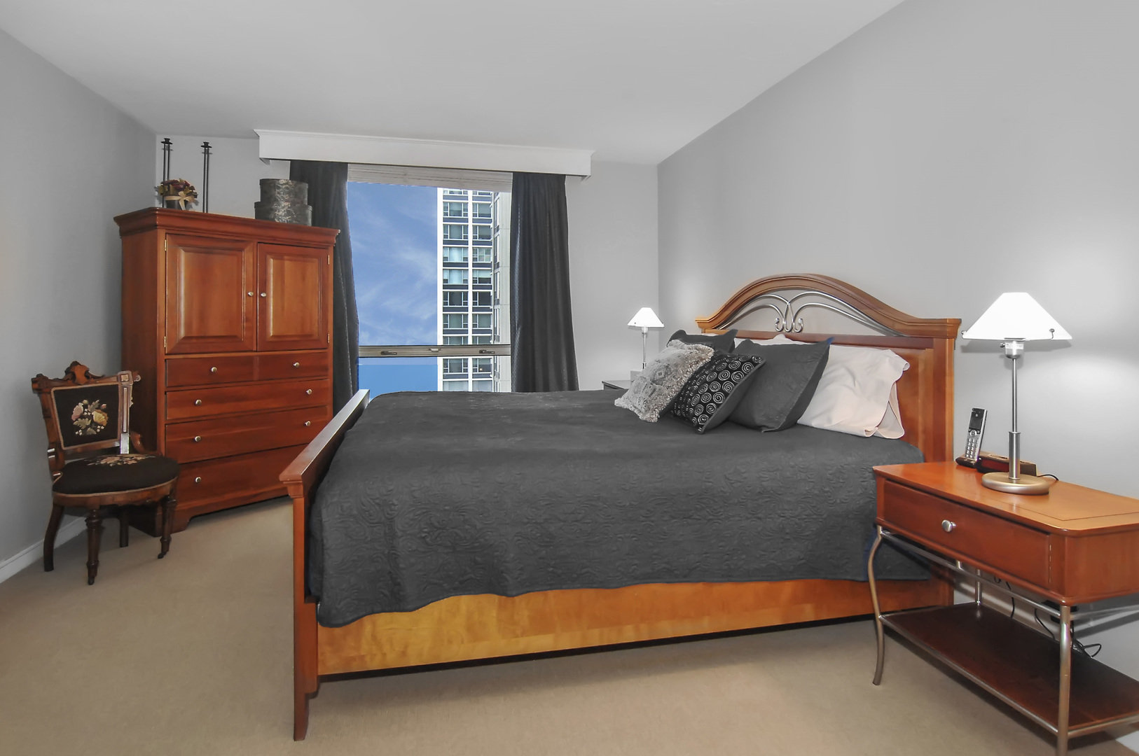 1310 North Ritchie Court, Unit 14C Chicago, IL 60610 - Photo 18 of 22 a bedroom with a bed and a lamp on table