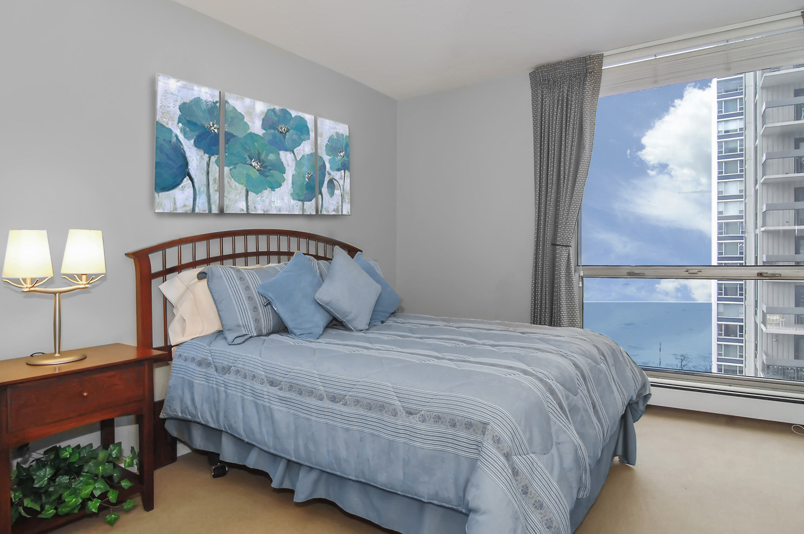 1310 North Ritchie Court, Unit 14C Chicago, IL 60610 - Photo 20 of 22 a bedroom with a large bed and a window
