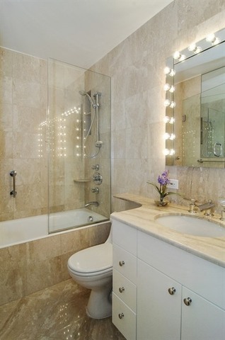 1310 North Ritchie Court, Unit 14C Chicago, IL 60610 - Photo 22 of 22 a bathroom with a granite countertop toilet a sink and a bathtub