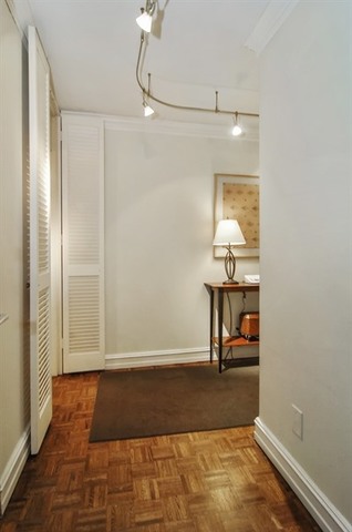 1310 North Ritchie Court, Unit 14C Chicago, IL 60610 - Photo 6 of 22 a view of a hallway with wooden floor and glass door