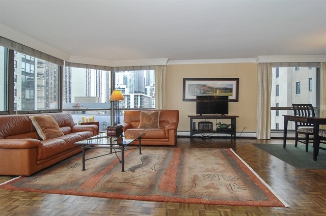 1310 North Ritchie Court, Unit 14C Chicago, IL 60610 - Photo 7 of 22 a living room with furniture and a flat screen tv