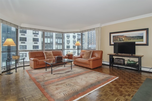 1310 North Ritchie Court, Unit 14C Chicago, IL 60610 - Photo 8 of 22 a living room with furniture and a flat screen tv