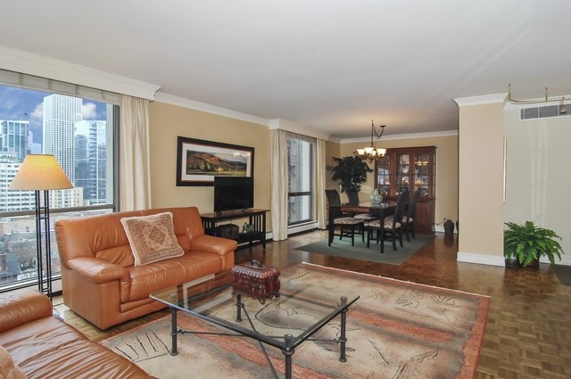 1310 North Ritchie Court, Unit 14C Chicago, IL 60610 - Photo 10 of 22 a living room with furniture and wooden floor