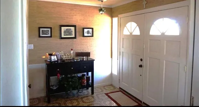 a view of living room with furniture and a fireplace