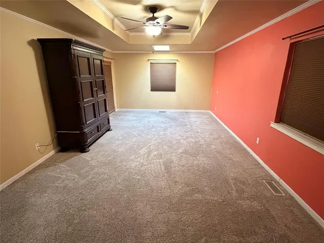 an empty room with windows and closet