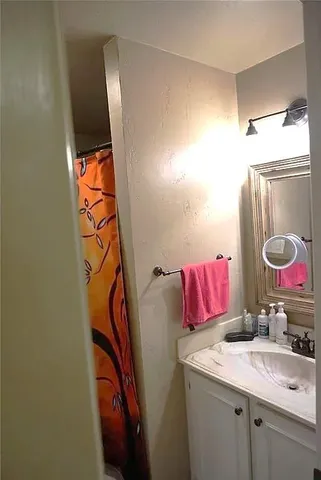 a bathroom with a toilet and a shower curtain