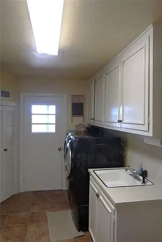 a view of a hallway to room with closet