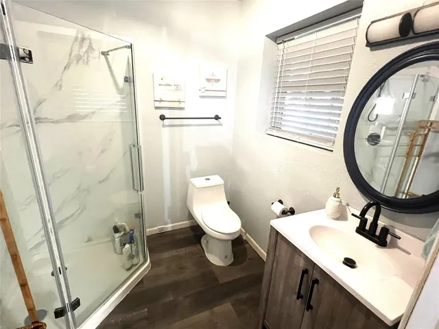 a bathroom with a glass shower door