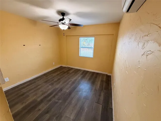 a view of a room with wooden floor a ceiling fan and closet