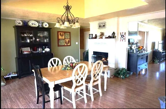 a view of a dining room with furniture wooden floor and chandelier