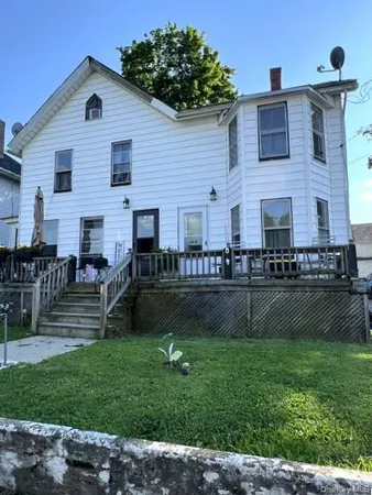 a front view of house with yard and outdoor seating