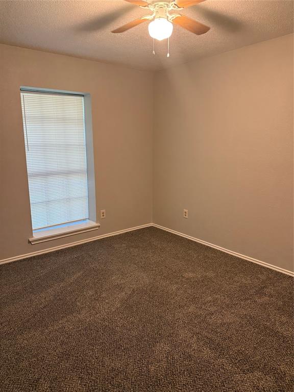 304 East Hickory Street, Unit B Kaufman, TX 75142 - Photo 14 of 14 an empty room with a window
