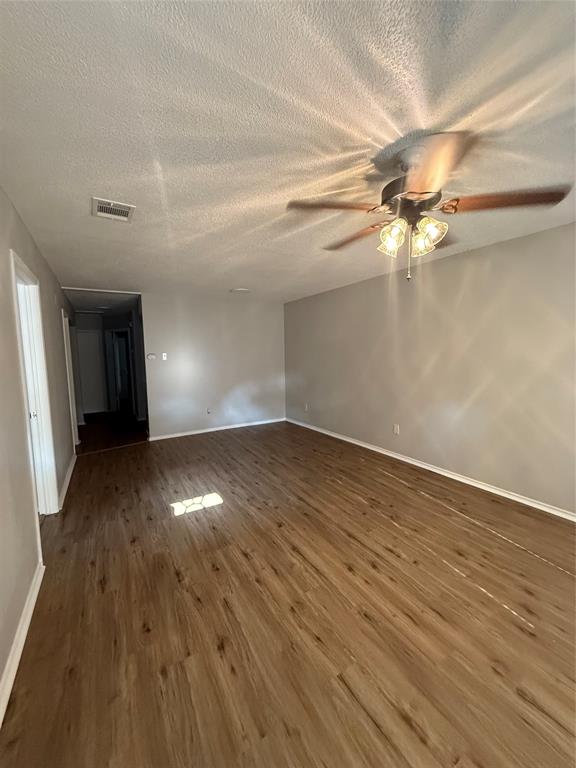 304 East Hickory Street, Unit B Kaufman, TX 75142 - Photo 5 of 14 wooden floor in an empty room with a window