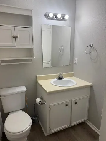 a bathroom with a toilet sink and mirror