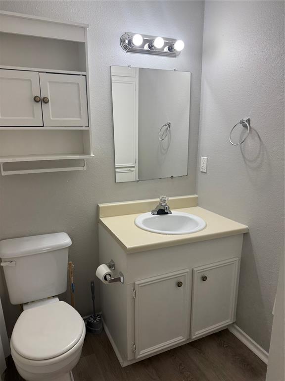 304 East Hickory Street, Unit B Kaufman, TX 75142 - Photo 8 of 14 a bathroom with a toilet sink and mirror