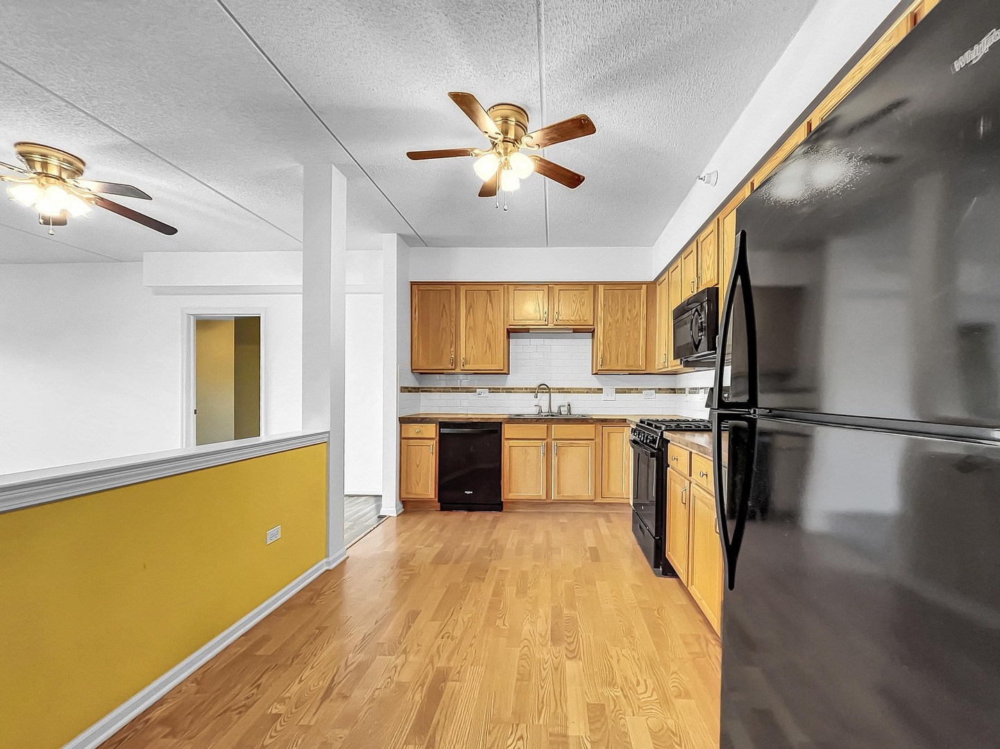 500 East St Charles Road, Unit 201 Lombard, IL 60148 - Photo 12 of 41 a kitchen with stainless steel appliances a refrigerator and a stove top oven