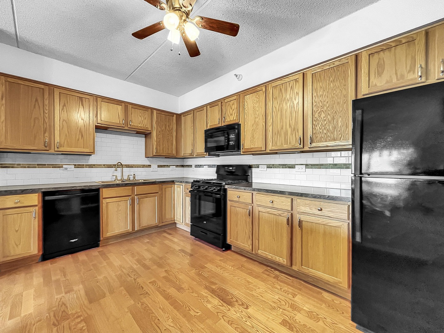 500 East St Charles Road, Unit 201 Lombard, IL 60148 - Photo 14 of 41 a kitchen with stainless steel appliances granite countertop a stove cabinets and a refrigerator