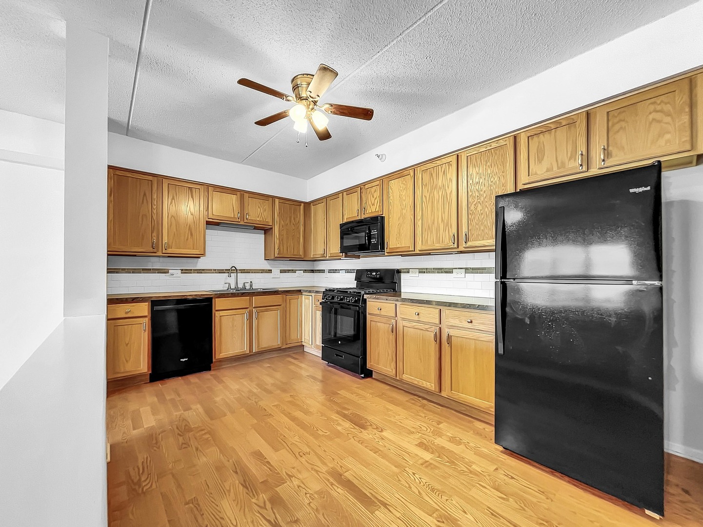 500 East St Charles Road, Unit 201 Lombard, IL 60148 - Photo 15 of 41 a kitchen with granite countertop stainless steel appliances cabinets a sink and a counter top space