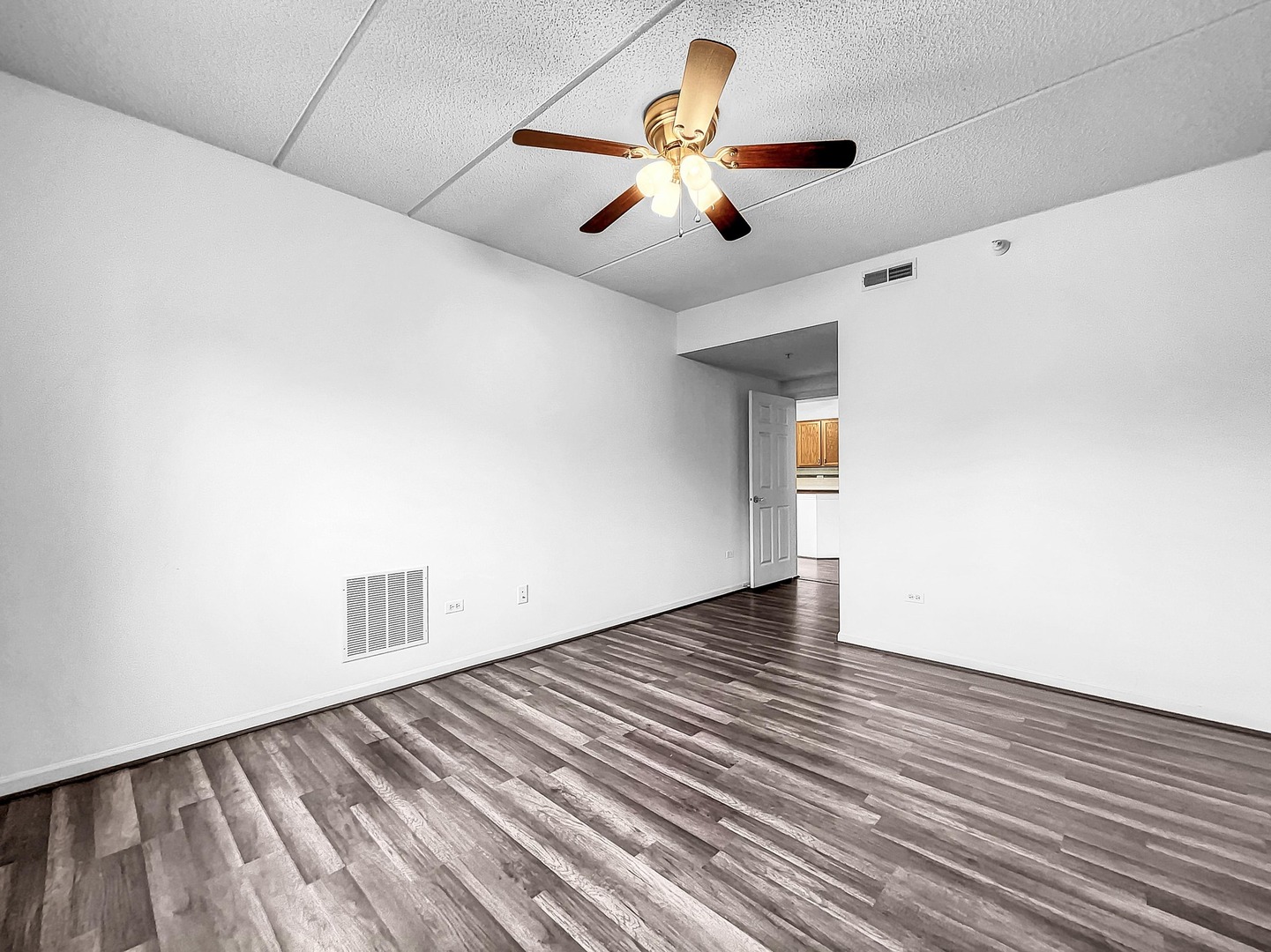 500 East St Charles Road, Unit 201 Lombard, IL 60148 - Photo 20 of 41 an empty room with wooden floor and chandelier fan