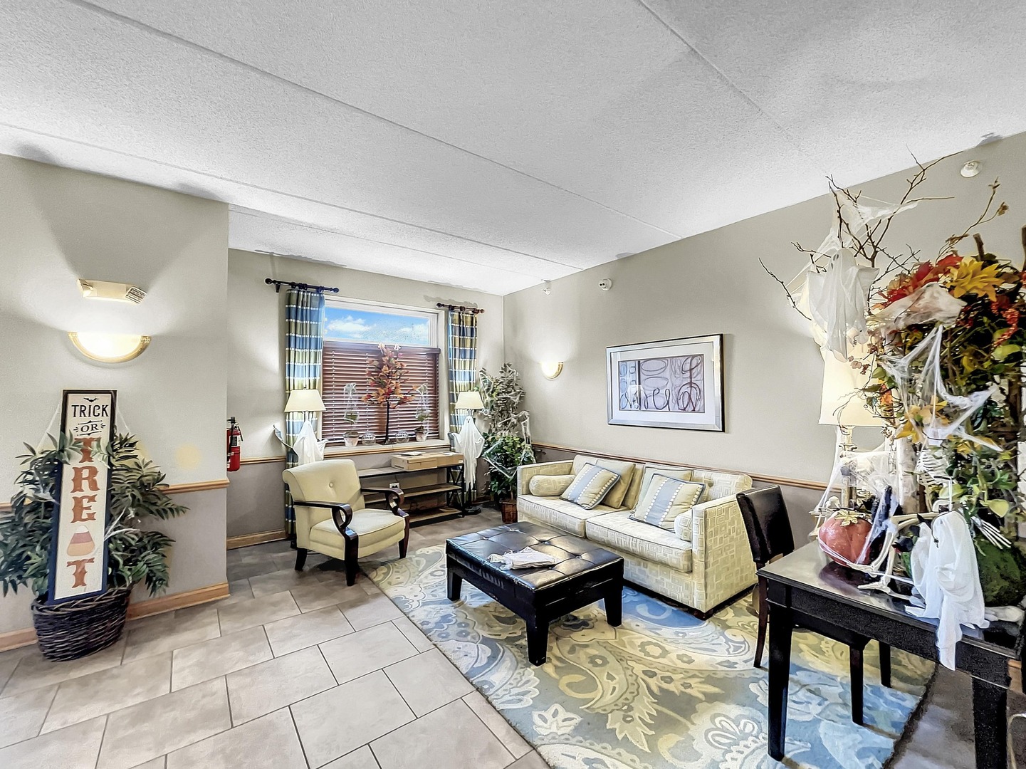 500 East St Charles Road, Unit 201 Lombard, IL 60148 - Photo 2 of 41 a living room with furniture and a potted plant