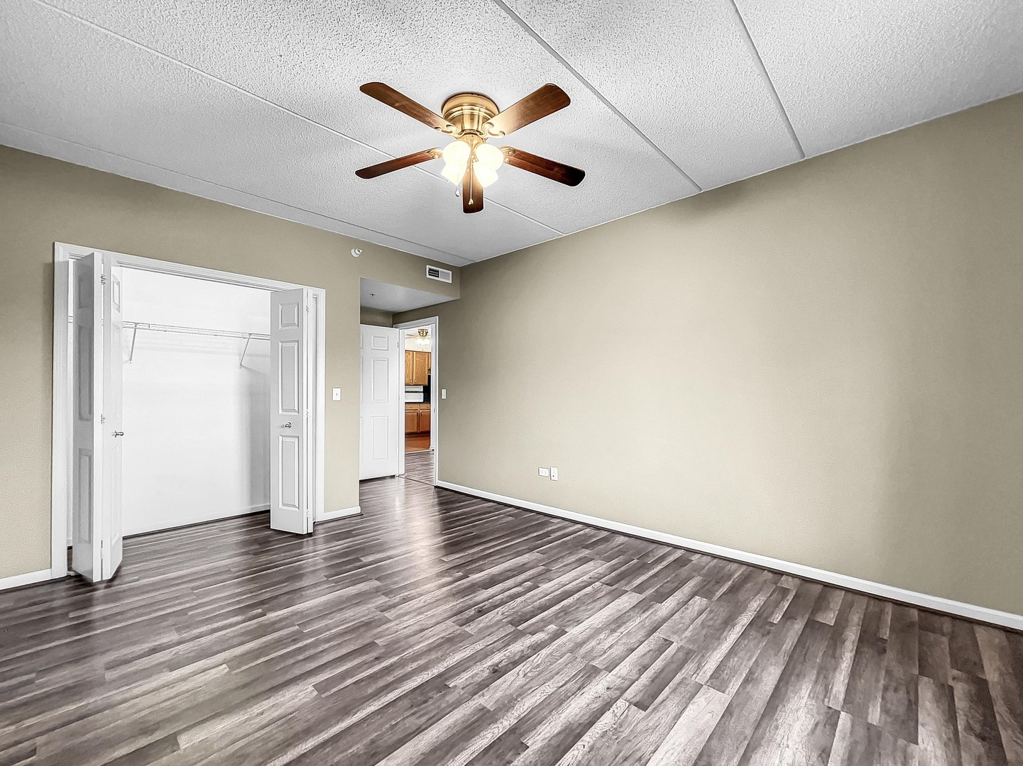 500 East St Charles Road, Unit 201 Lombard, IL 60148 - Photo 22 of 41 an empty room with wooden floor and windows