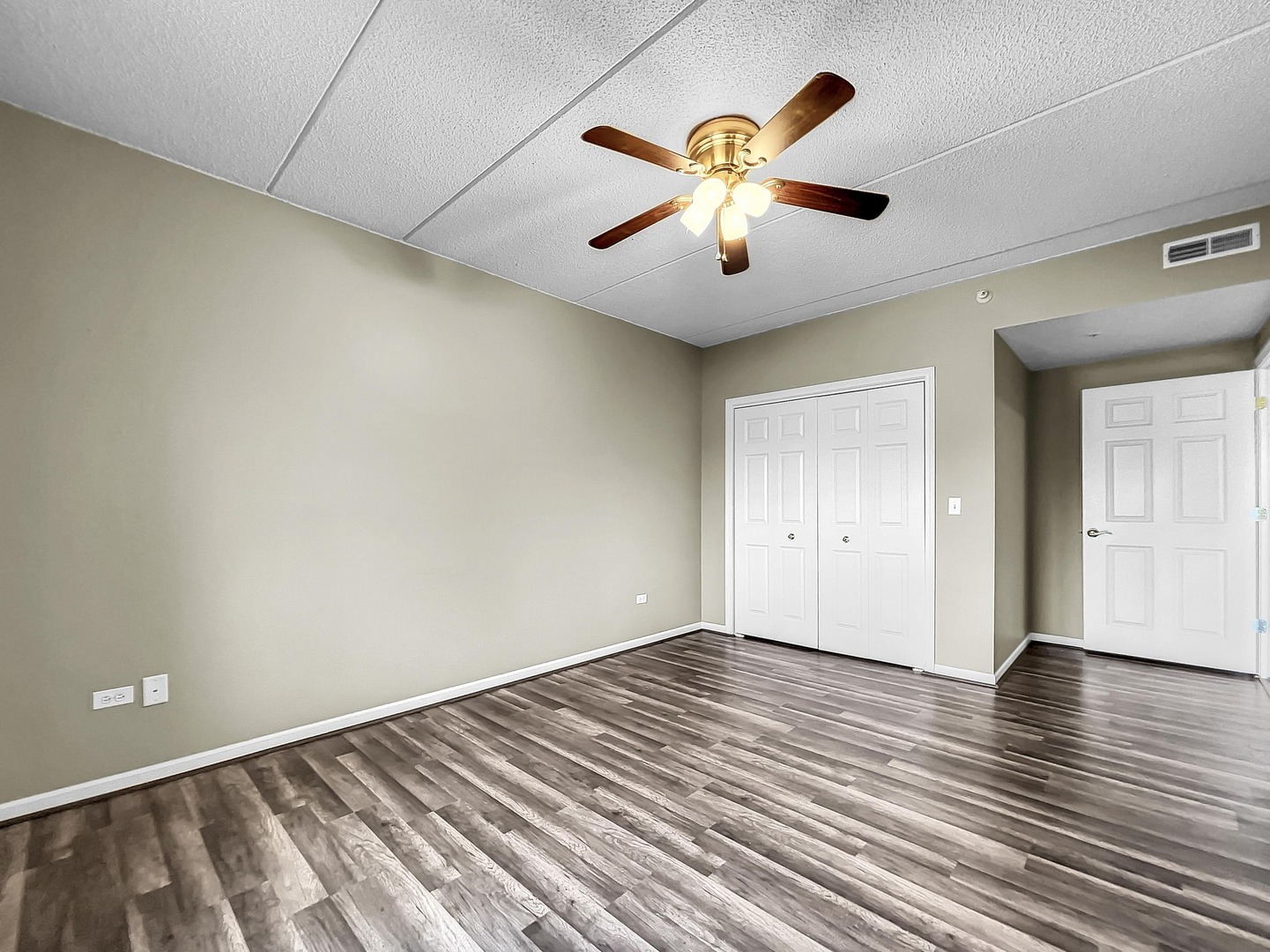 500 East St Charles Road, Unit 201 Lombard, IL 60148 - Photo 23 of 41 an empty room with wooden floor and windows