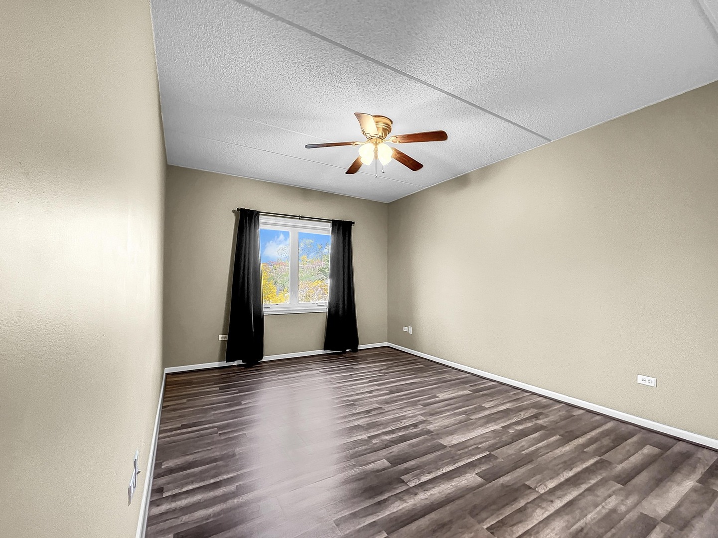 500 East St Charles Road, Unit 201 Lombard, IL 60148 - Photo 24 of 41 a view of an empty room with window and wooden floor