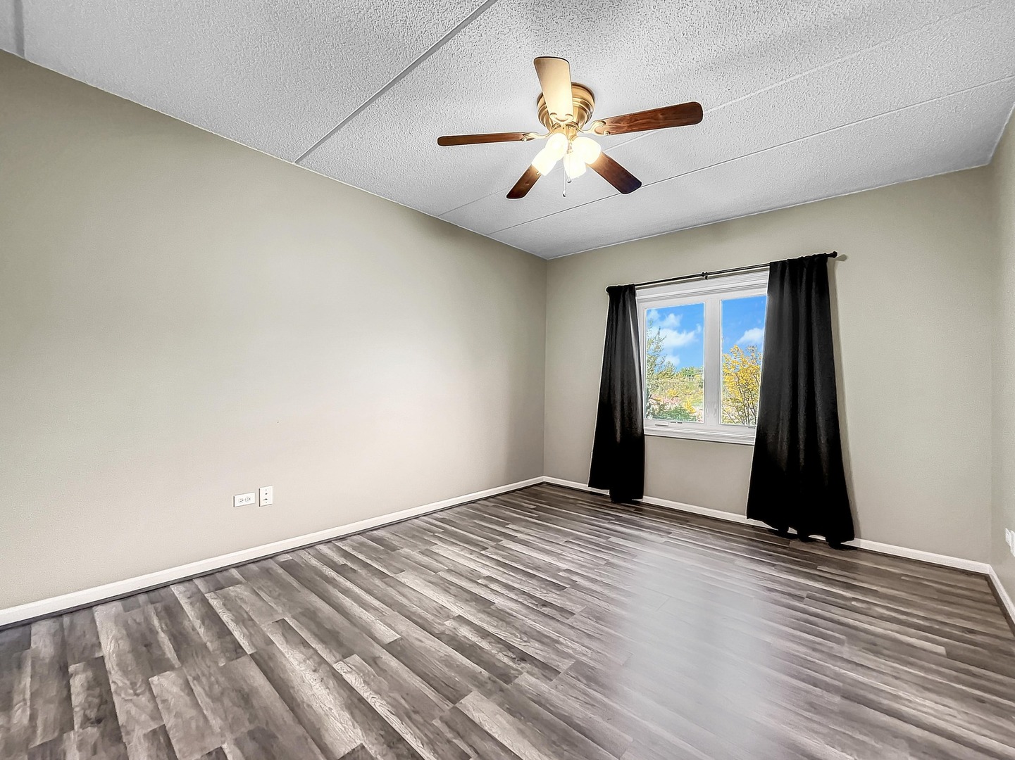 500 East St Charles Road, Unit 201 Lombard, IL 60148 - Photo 25 of 41 a view of an empty room with wooden floor and a window