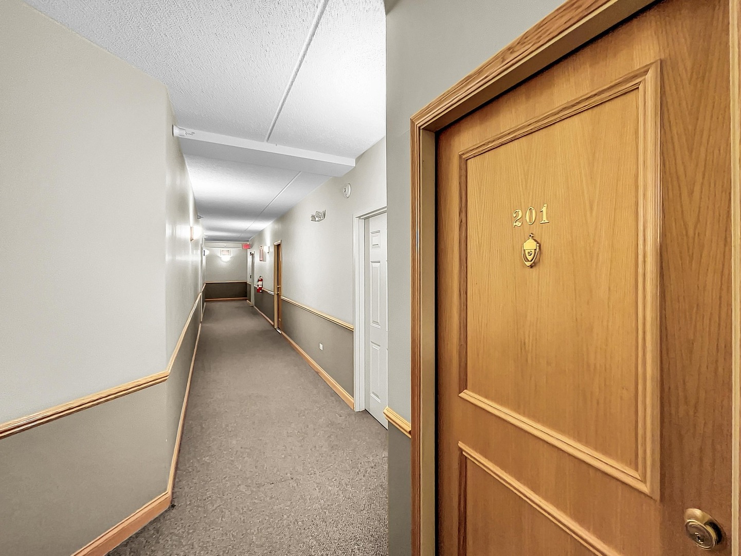 500 East St Charles Road, Unit 201 Lombard, IL 60148 - Photo 35 of 41 a view of a hallway with wooden floor and staircase