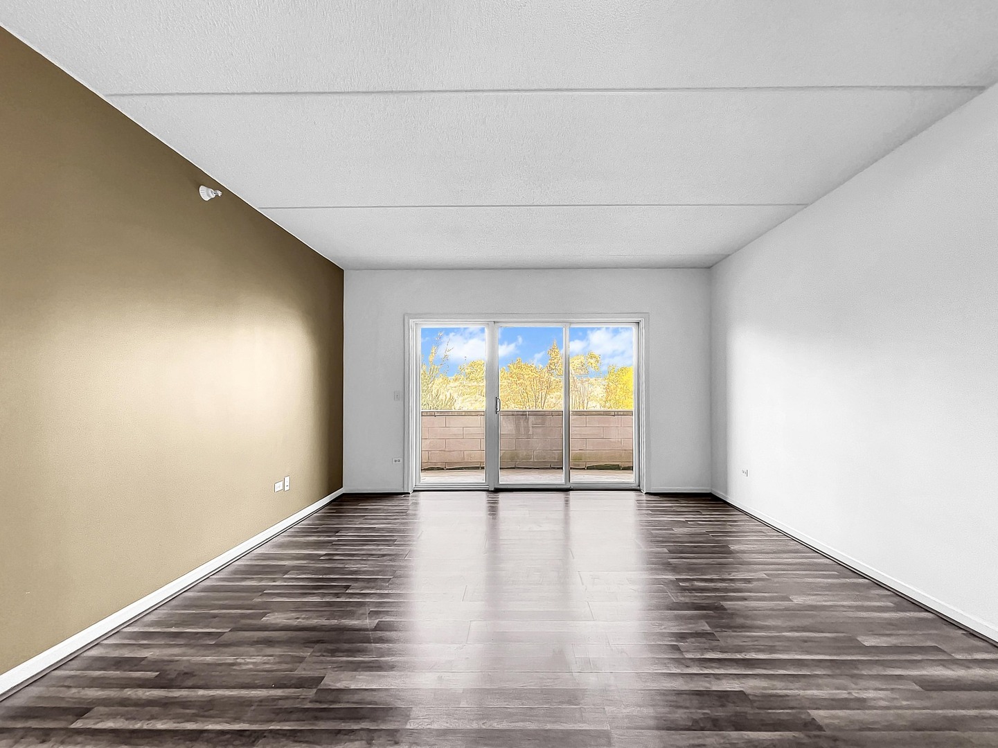 500 East St Charles Road, Unit 201 Lombard, IL 60148 - Photo 5 of 41 a view of an empty room with wooden floor and a window