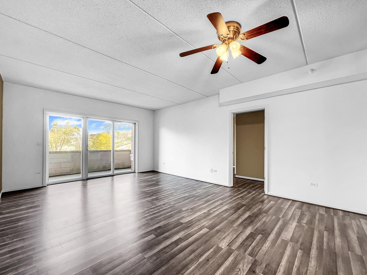 500 East St Charles Road, Unit 201 Lombard, IL 60148 - Photo 6 of 41 a view of an empty room with window and wooden floor