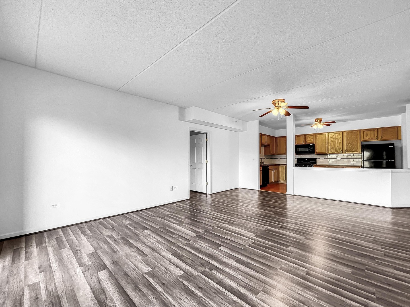 500 East St Charles Road, Unit 201 Lombard, IL 60148 - Photo 8 of 41 a view of a kitchen with wooden floor and a refrigerator