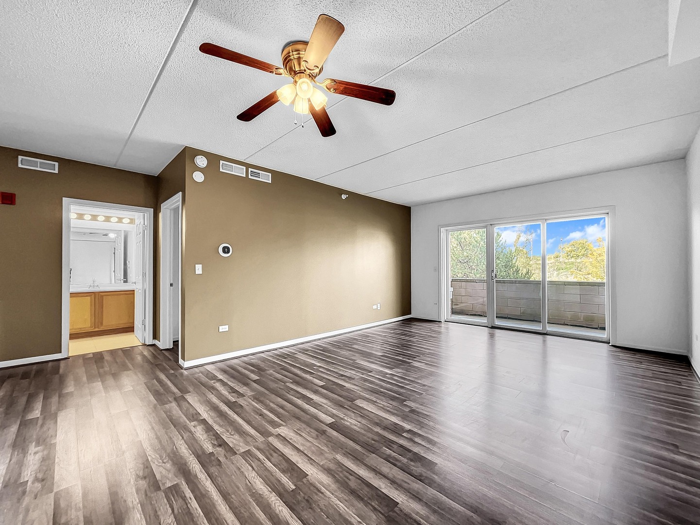 500 East St Charles Road, Unit 201 Lombard, IL 60148 - Photo 9 of 41 an empty room with wooden floor and windows