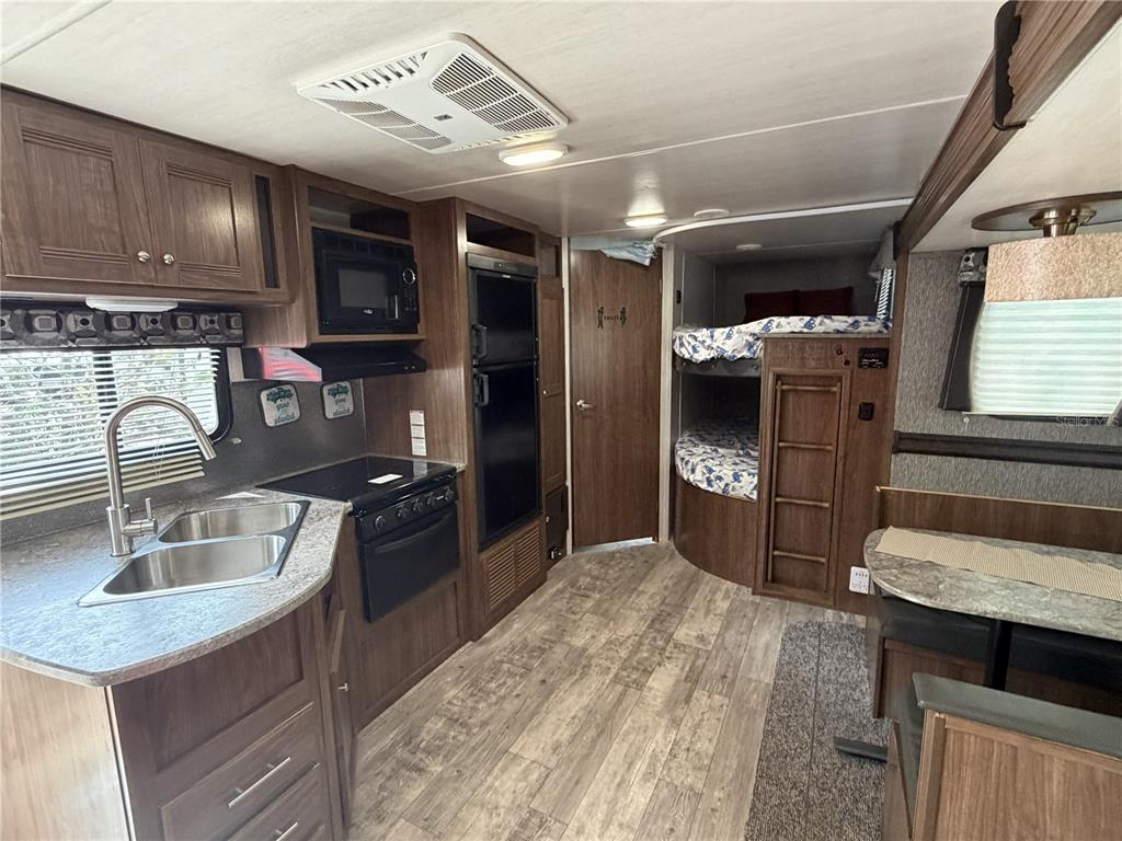 3000 Clarcona Road, Unit 743 Apopka, FL 32703 - Photo 21 of 54 a kitchen with stainless steel appliances granite countertop a sink stove and refrigerator