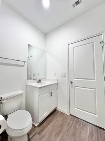 a bathroom with a toilet a sink and mirror