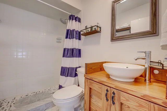 a white toilet sitting next to a bathroom sink