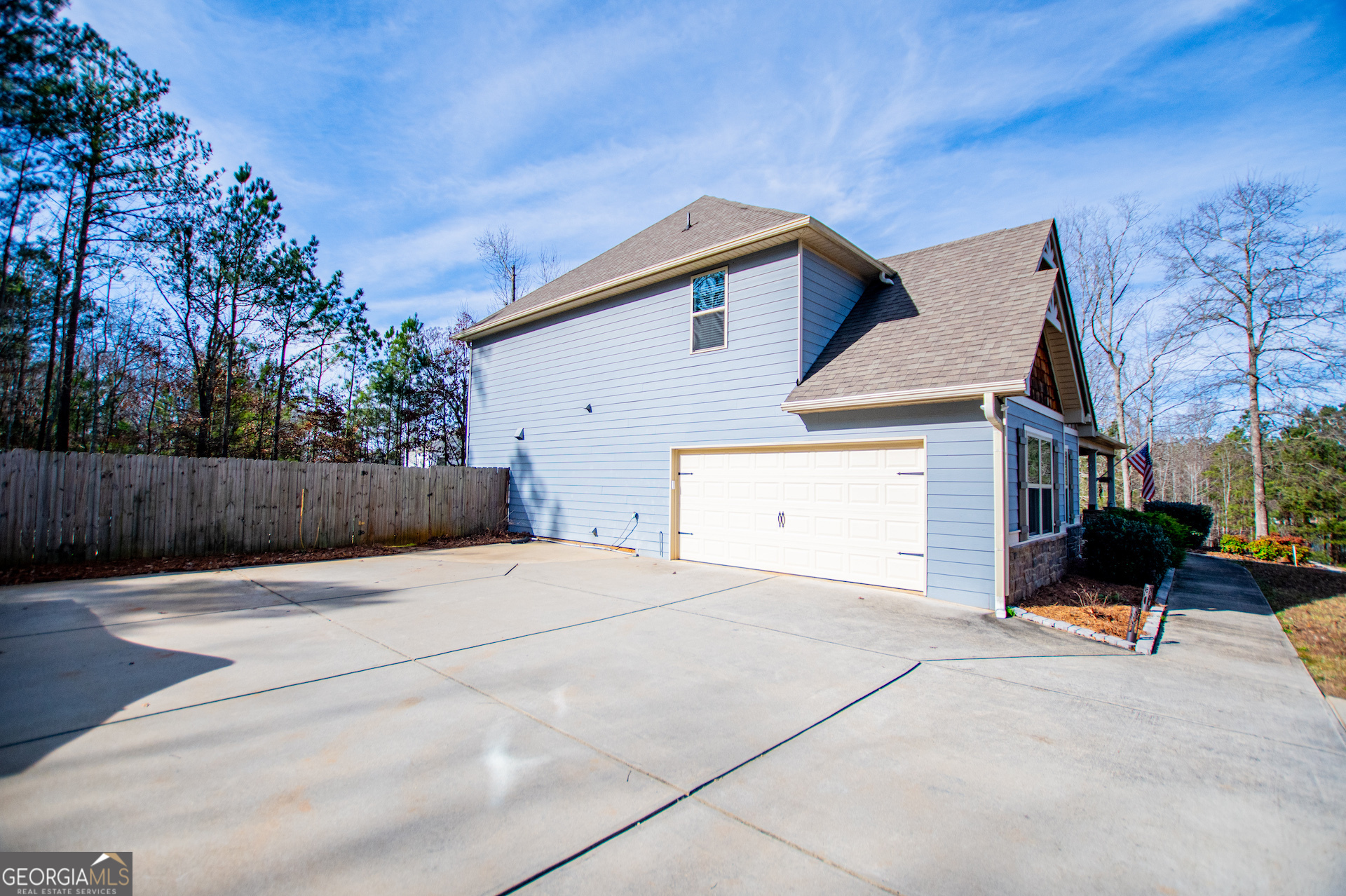 201 Overton Point Carrollton, GA 30116 - Photo 14 of 87 a backyard of a house with wooden fence and trees