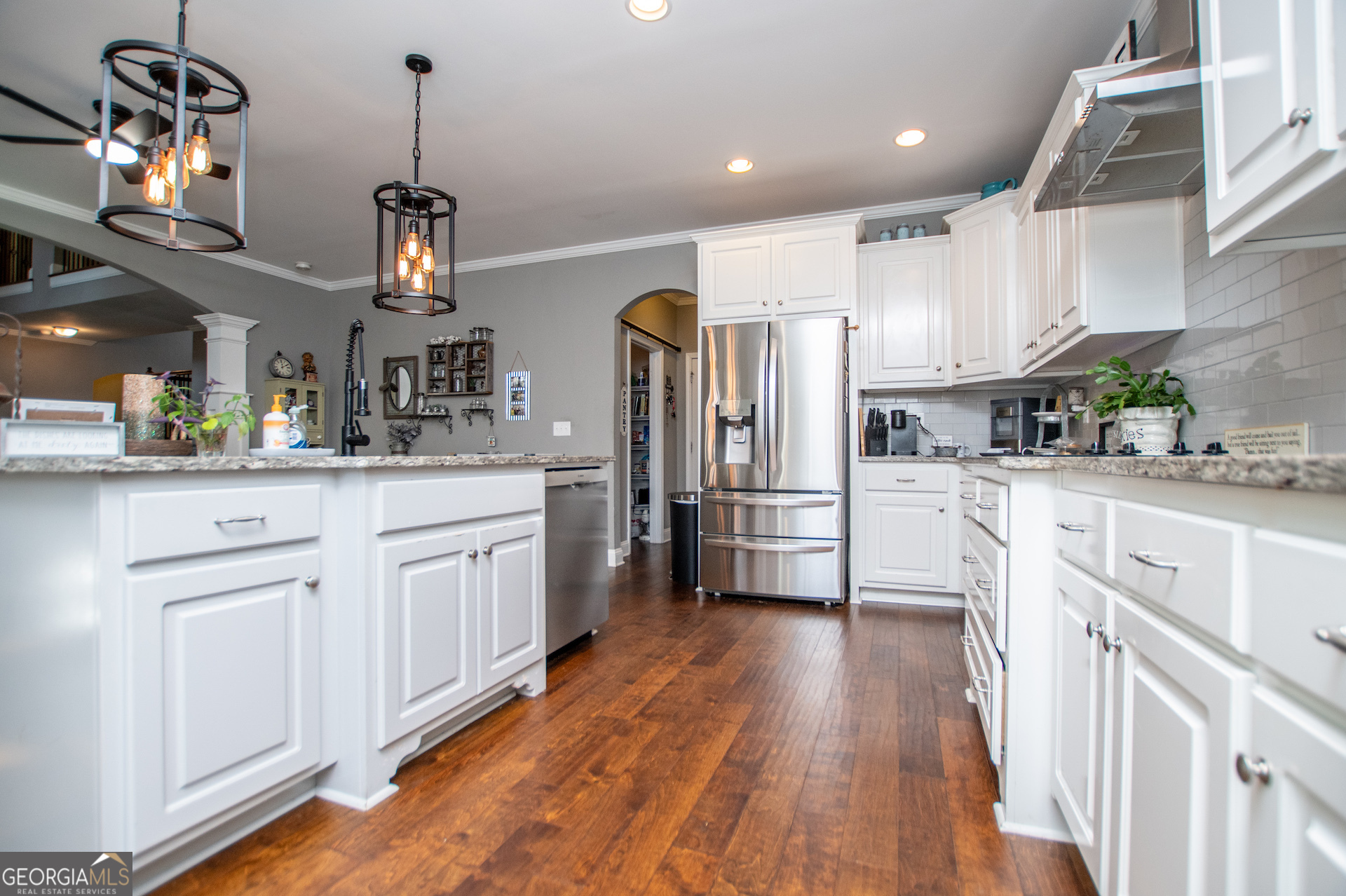 201 Overton Point Carrollton, GA 30116 - Photo 25 of 87 a kitchen with granite countertop a refrigerator a sink dishwasher a stove and white cabinets with wooden floor