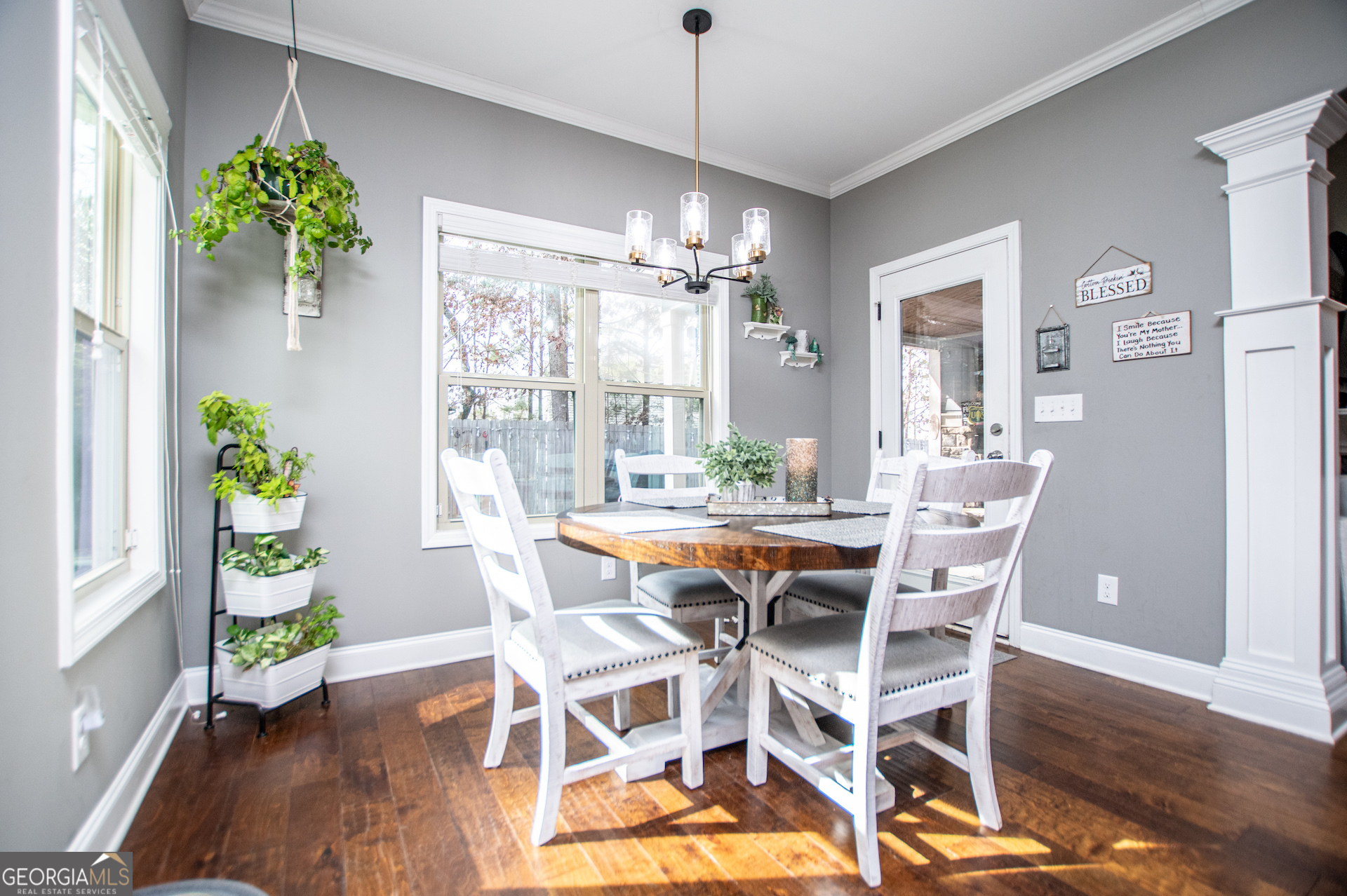 201 Overton Point Carrollton, GA 30116 - Photo 30 of 87 a dining room with furniture potted plants and wooden floor