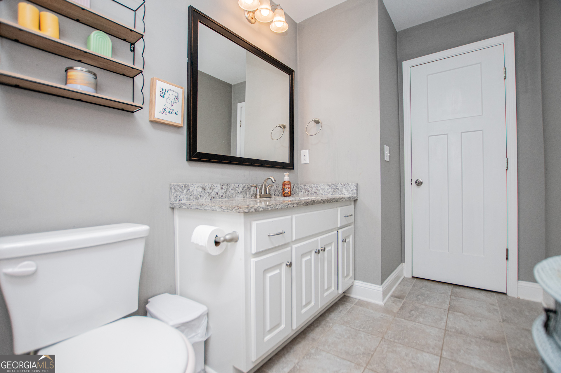 201 Overton Point Carrollton, GA 30116 - Photo 71 of 87 a bathroom with a granite countertop toilet sink and mirror