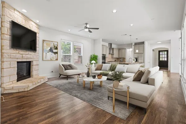 a living room with fireplace furniture and a flat screen tv