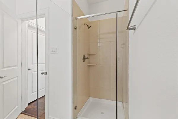 a bathroom with a glass shower door