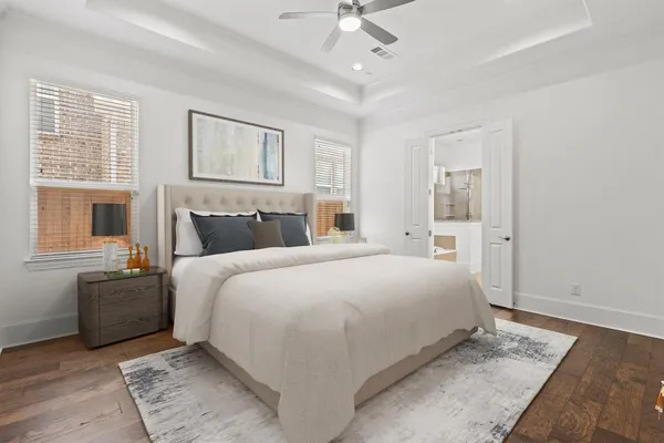 a bedroom with a large bed and a chandelier
