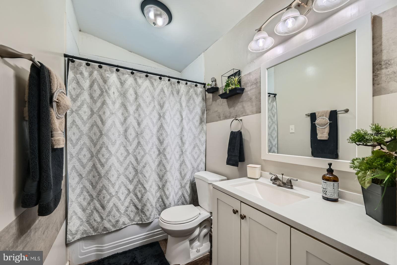 1201 Cobb Road Baltimore, MD 21208 - Photo 16 of 28 a bathroom with a sink toilet and shower