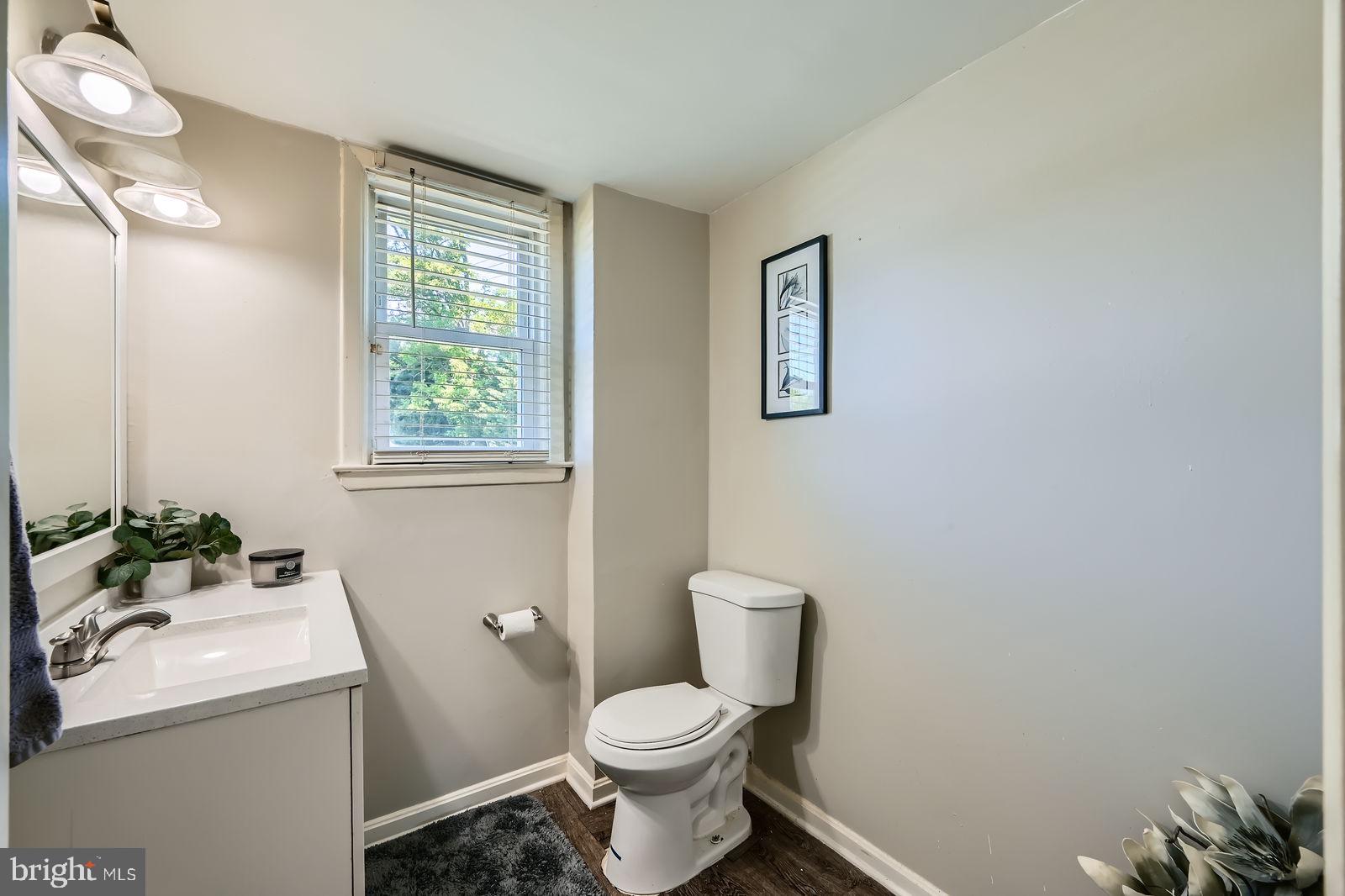1201 Cobb Road Baltimore, MD 21208 - Photo 20 of 28 a white toilet sitting next to a bathroom sink