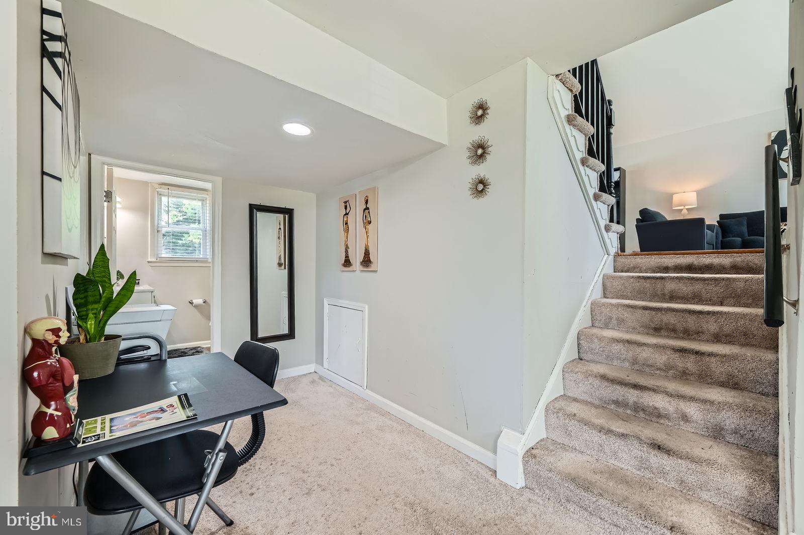 1201 Cobb Road Baltimore, MD 21208 - Photo 22 of 28 a view of a livingroom with furniture and a potted plant