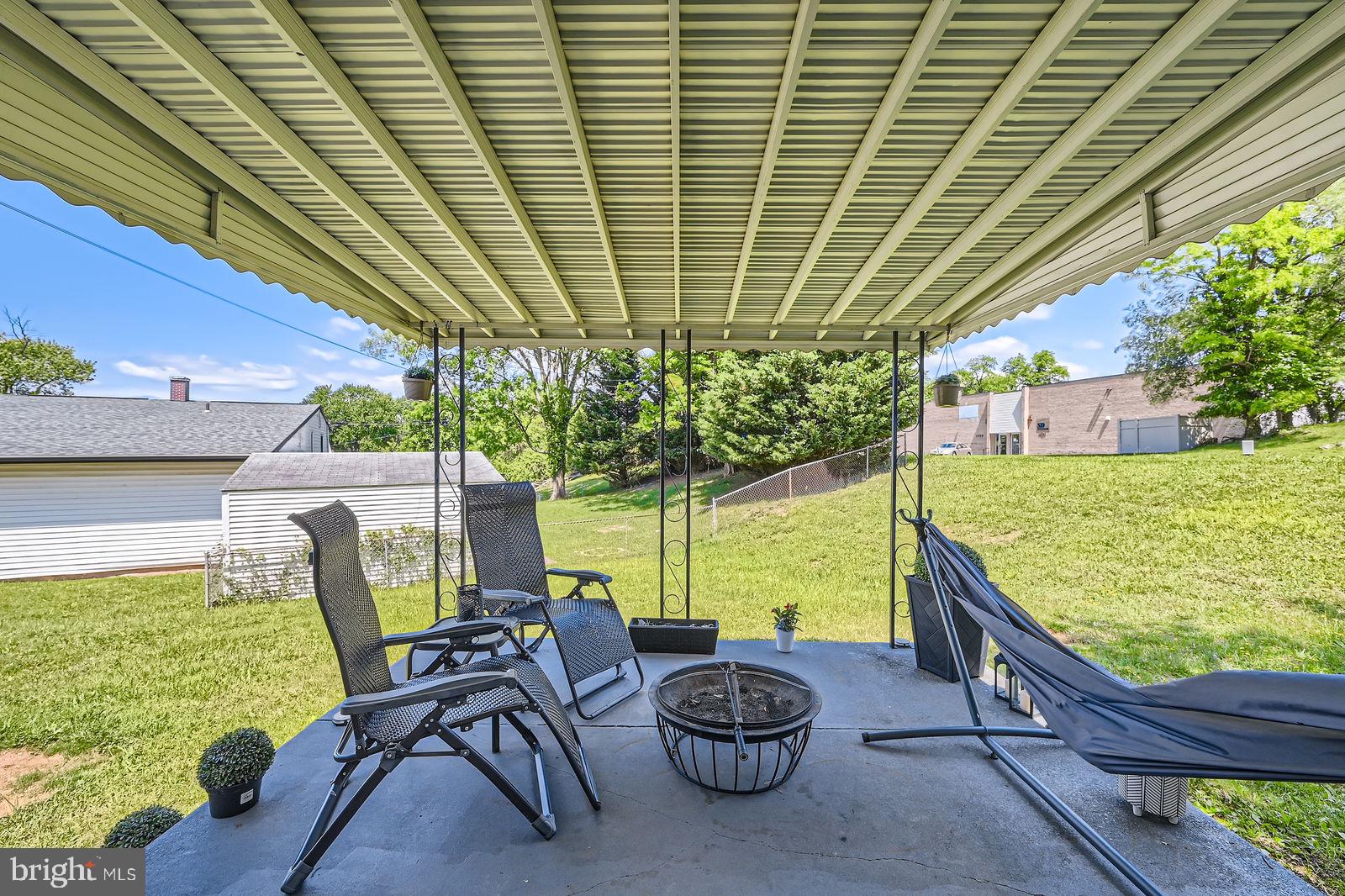 1201 Cobb Road Baltimore, MD 21208 - Photo 23 of 28 a view of a chairs and table in patio with a backyard
