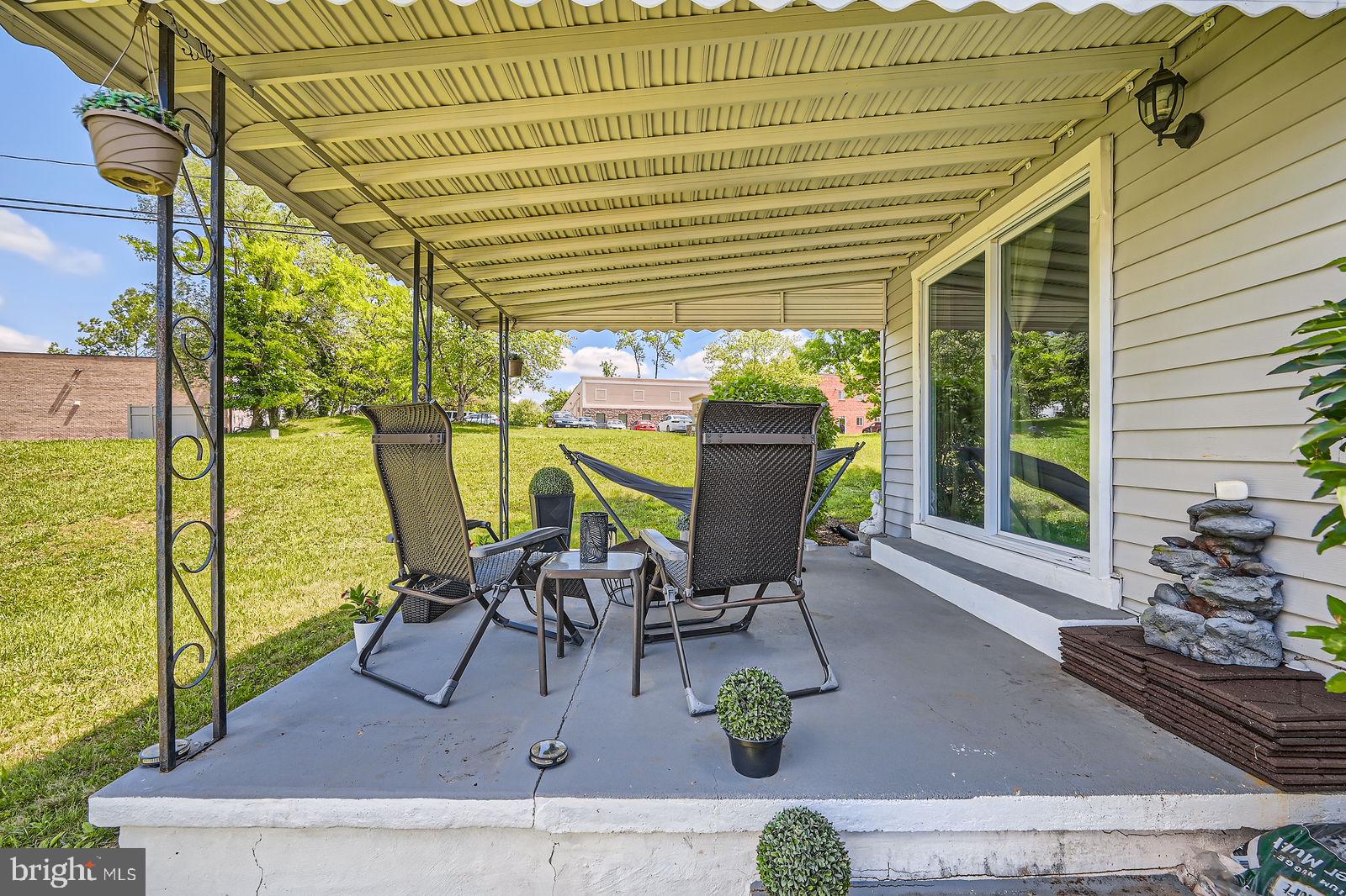 1201 Cobb Road Baltimore, MD 21208 - Photo 24 of 28 a view of a patio with table and chairs and potted plants