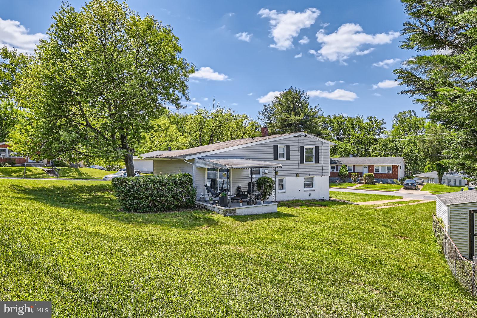 1201 Cobb Road Baltimore, MD 21208 - Photo 25 of 28 a view of a house with a big yard and large trees
