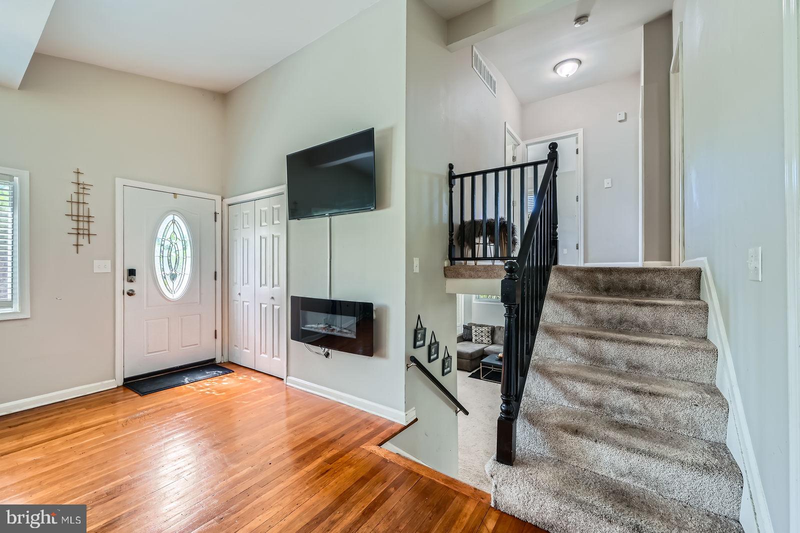1201 Cobb Road Baltimore, MD 21208 - Photo 4 of 28 a view of a livingroom with wooden floor and a flat screen tv